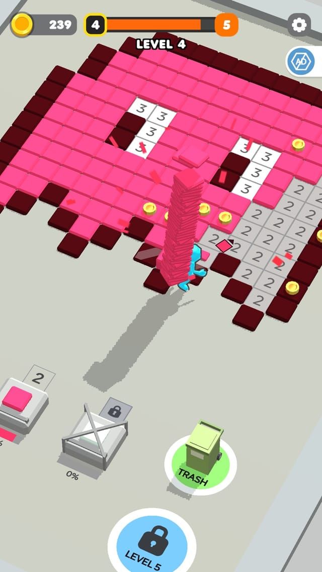 A worker carries a stack of pink tiles onto a numbered grid where part of the picture has already been laid in.