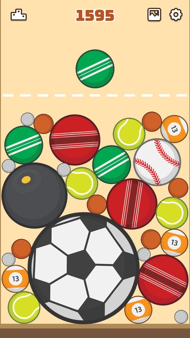 Spor teması: kabın dibinde bir futbol topu, çevresinde tenis ve kriket topları ile bir bowling topu sıkışmış.