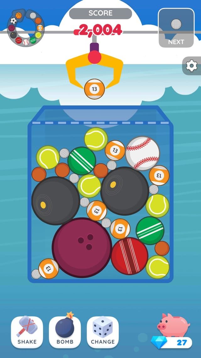 The sports theme, tennis balls and baseballs settling around a bowling ball at the bottom of the jar.