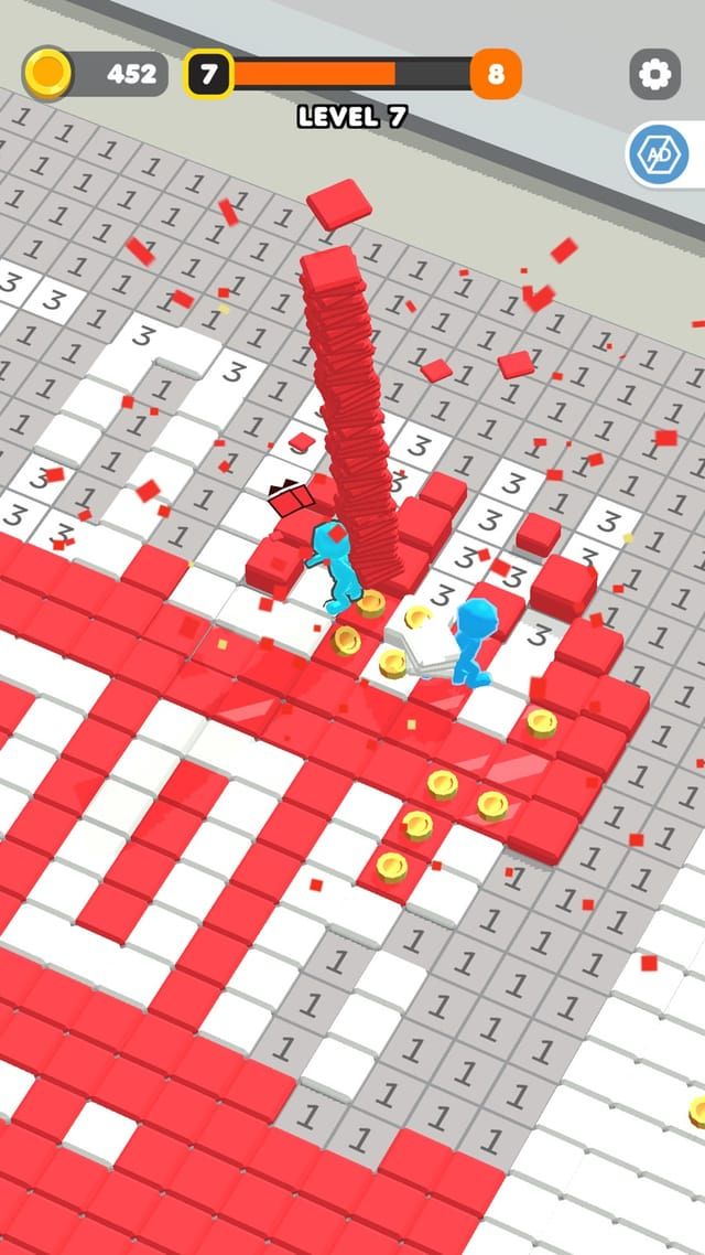 A picture in progress on a dense numbered grid, red tiles filling in the pattern while coins drop around the worker.